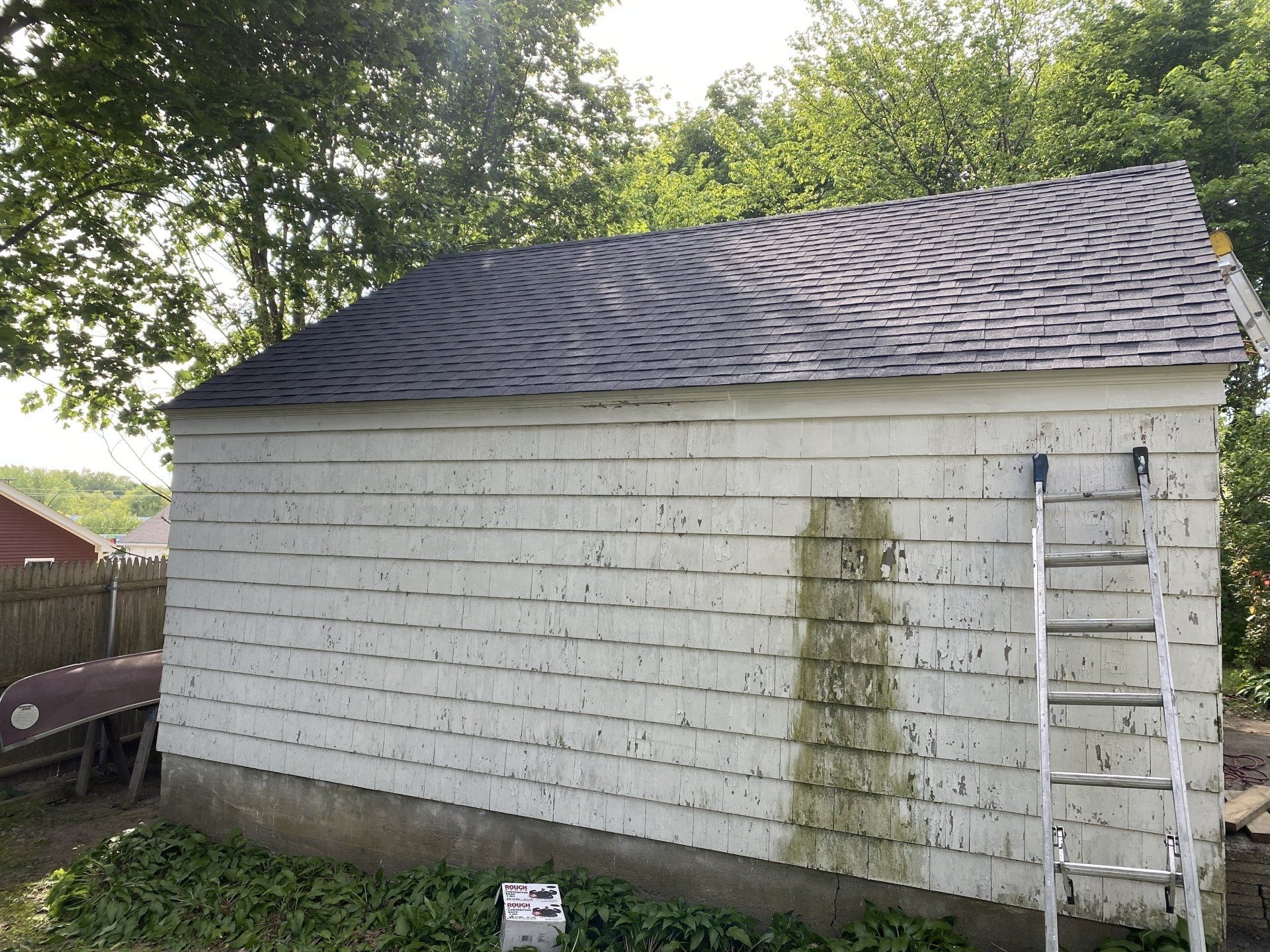 small white house with blue roof and stairs