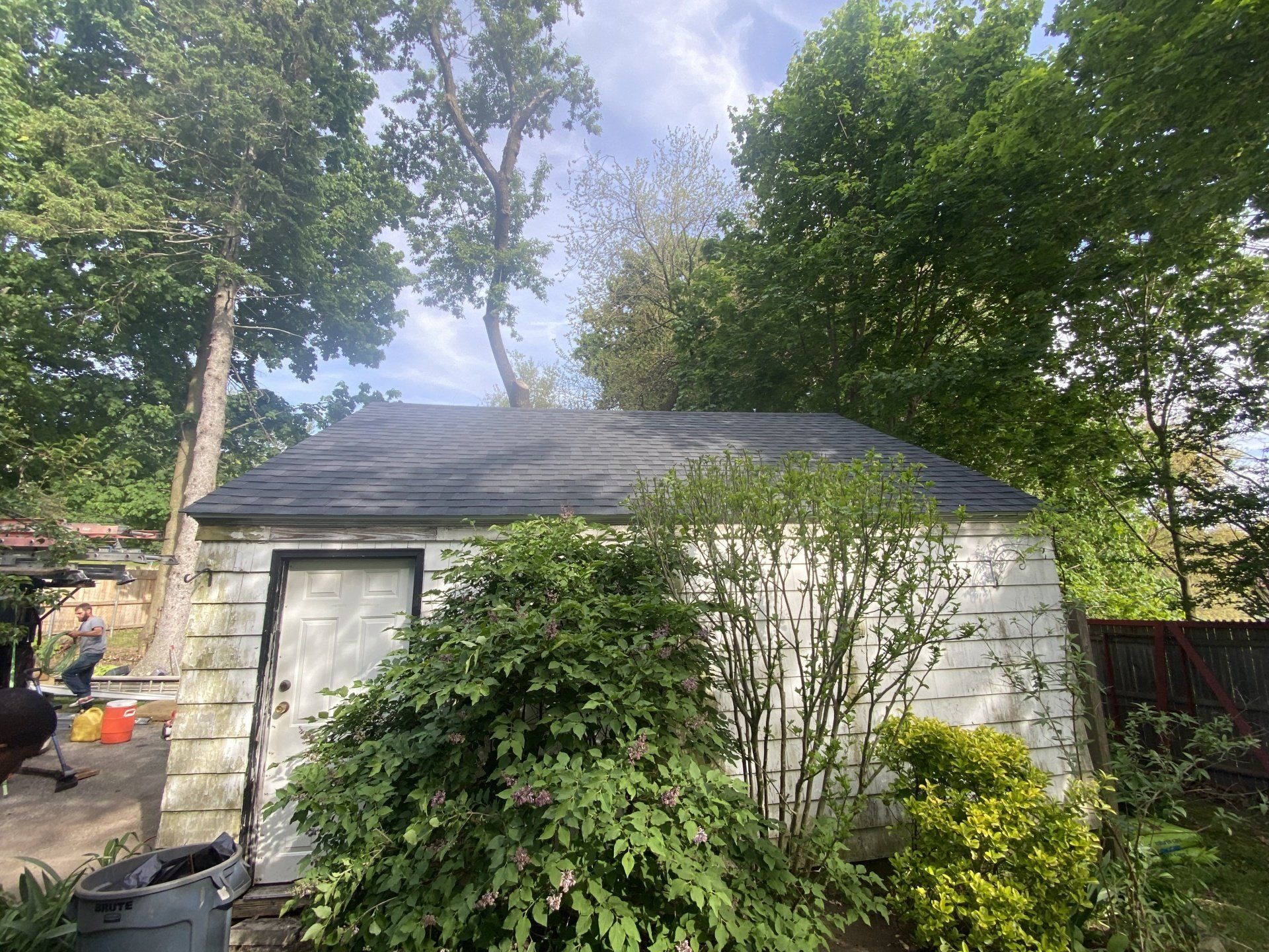 small white house with blue roof