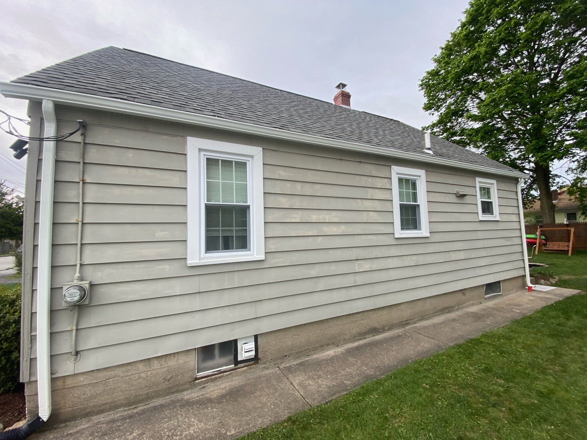 small light gray house with dark gray roof