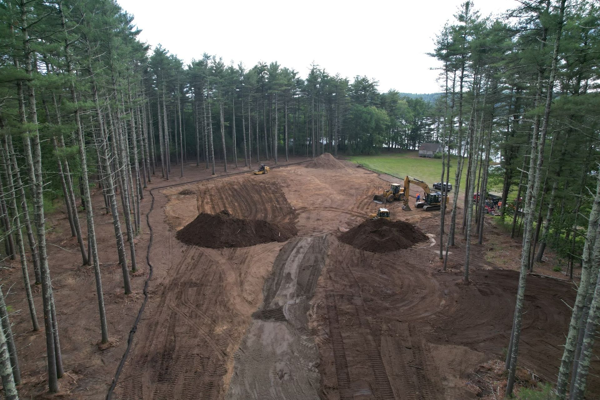 An aerial view of a construction site in the middle of a forest