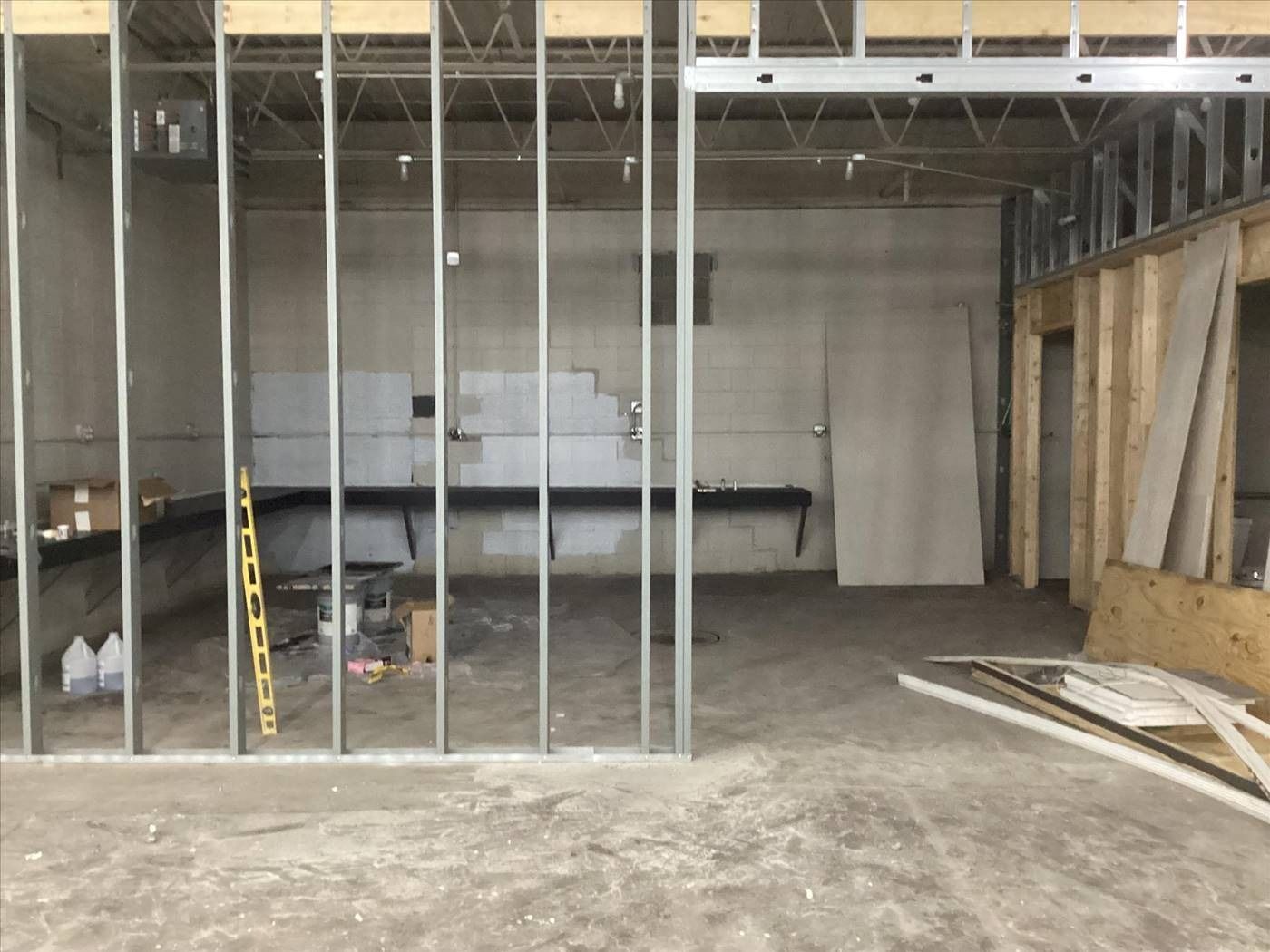 Unfinished interior with metal framing, concrete floor, and exposed walls under construction
