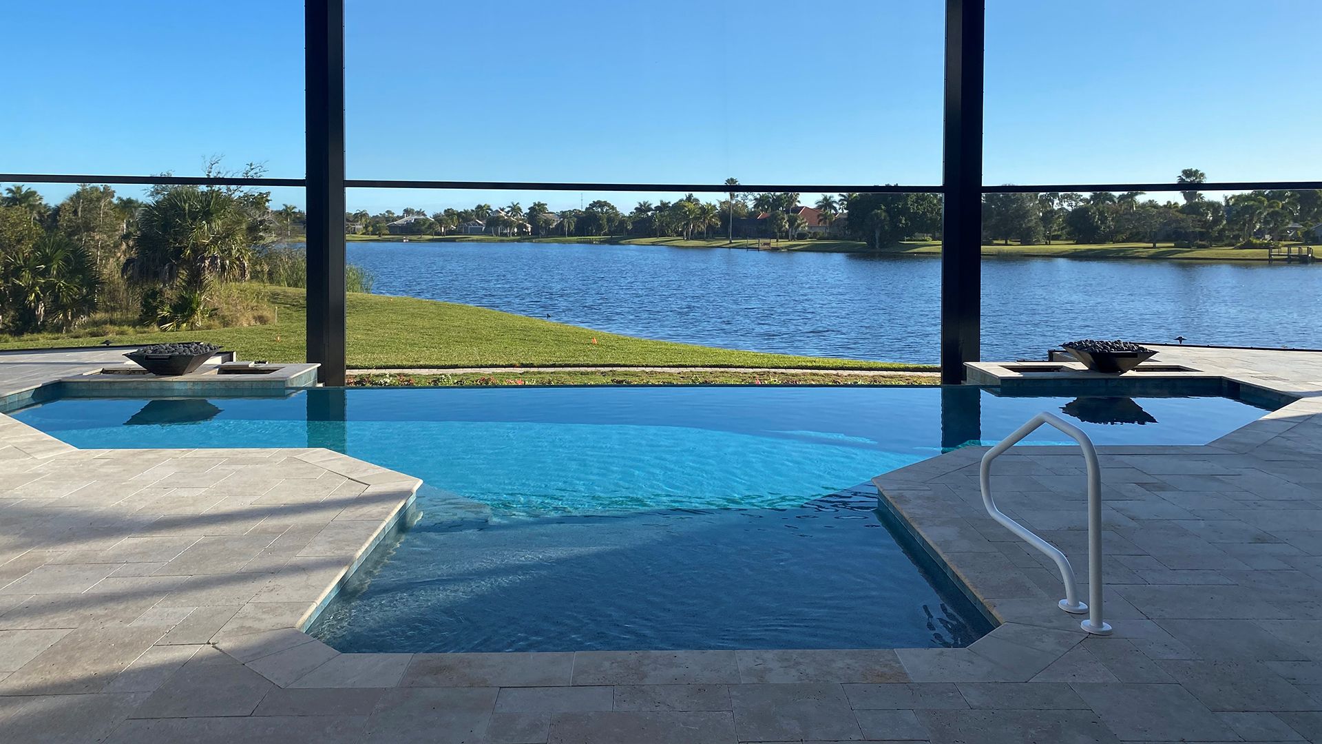 a large swimming pool with a view of a lake