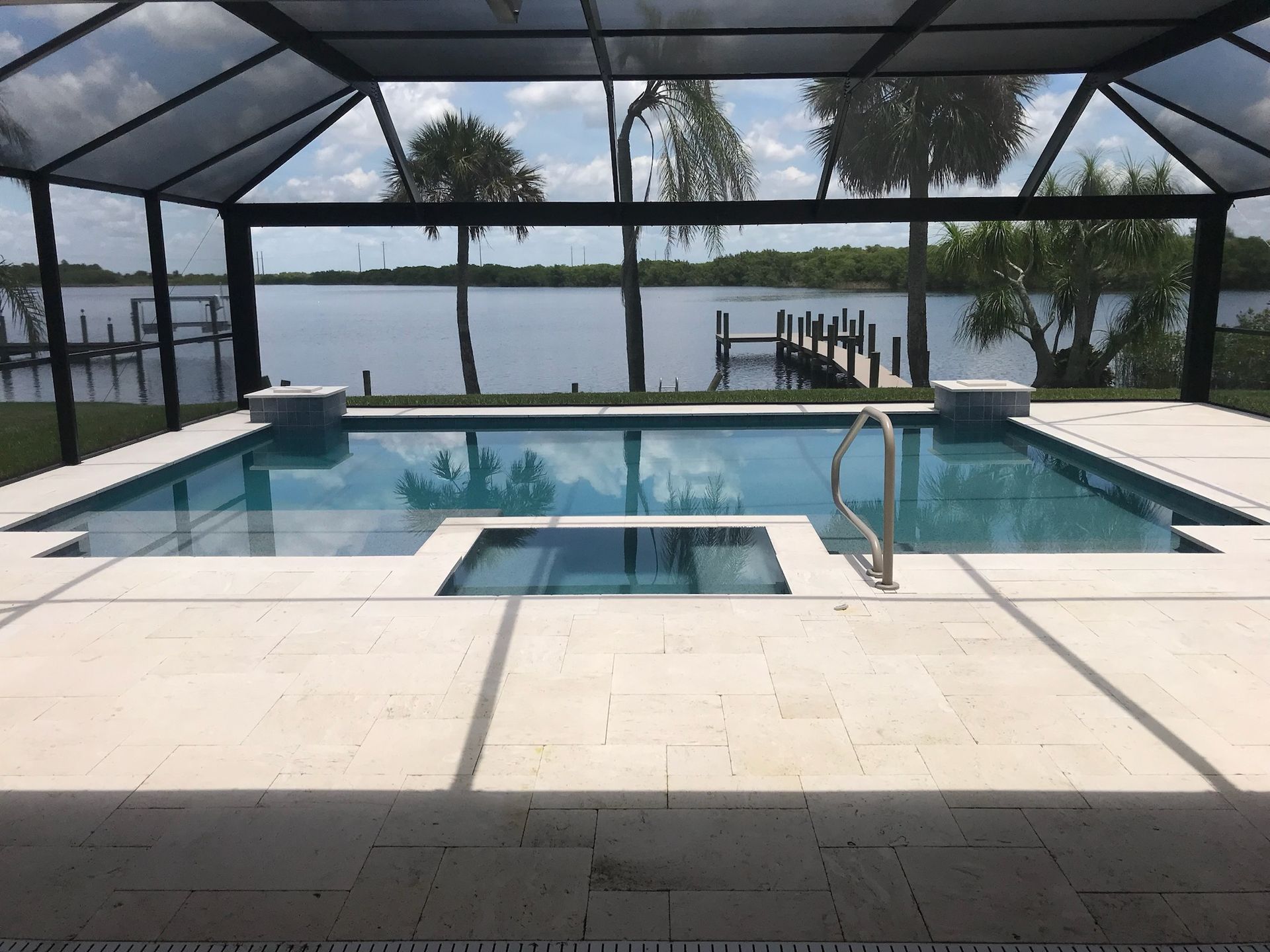 A large swimming pool with a view of a lake