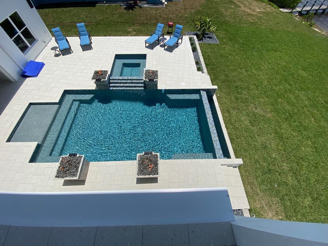 an aerial view of a large swimming pool in a backyard