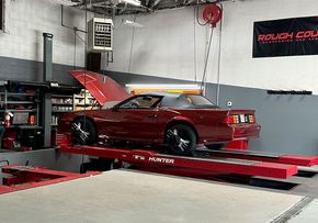 red vehicle on the alignment rack