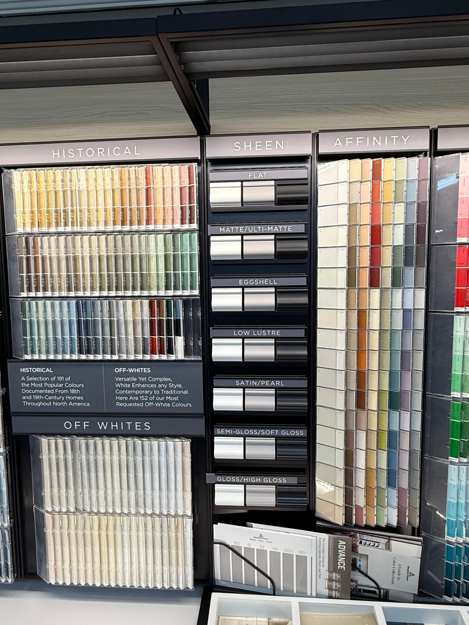 Paint color swatches organized by color on display shelves.