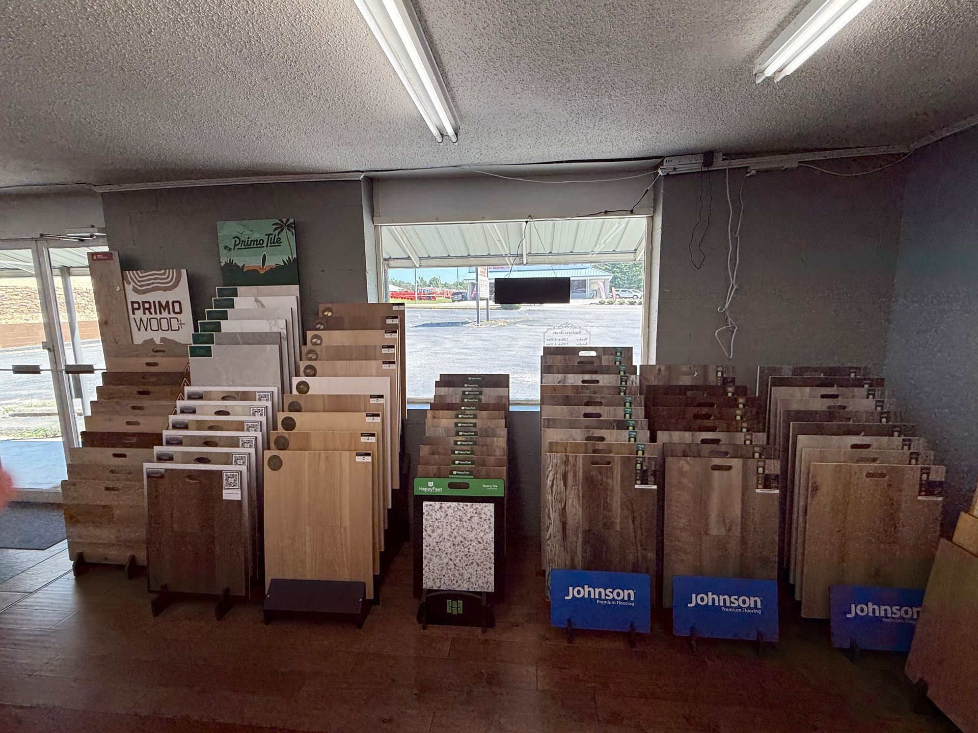 Tile samples displayed in a store with a window in the background.