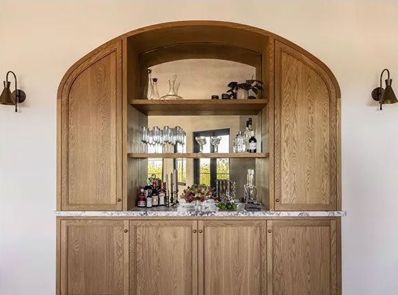 Learn more about Cabinets A wooden cabinet with a bar inside of it.
