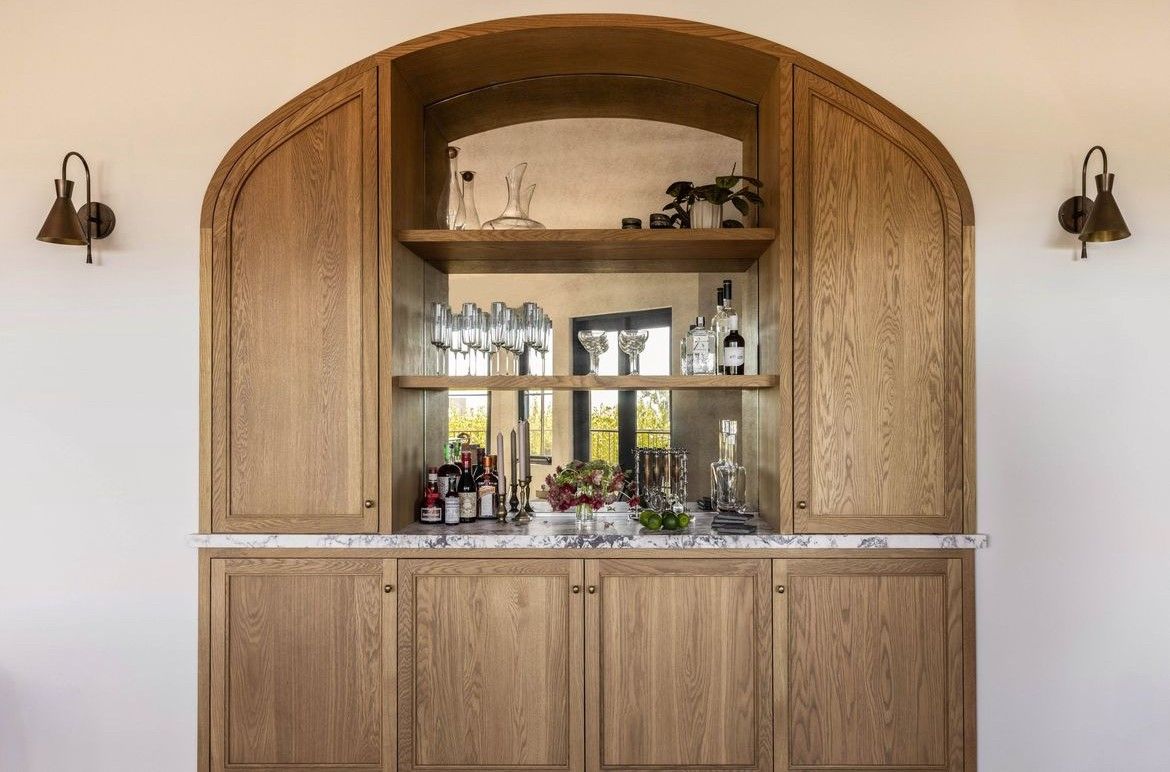 A large wooden cabinet with a bar inside of it.