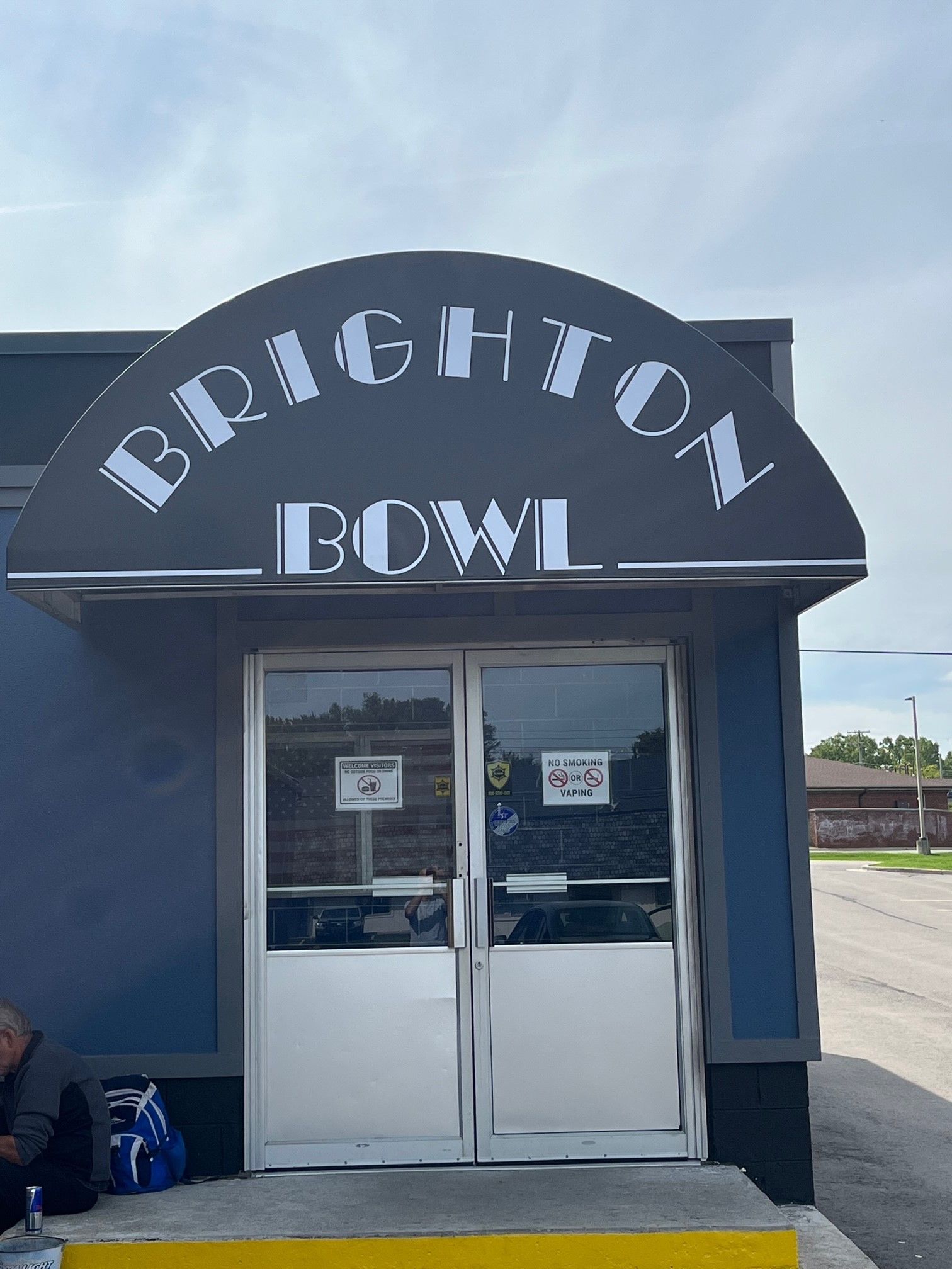 Brighton BCW building entrance with double doors and awning signage