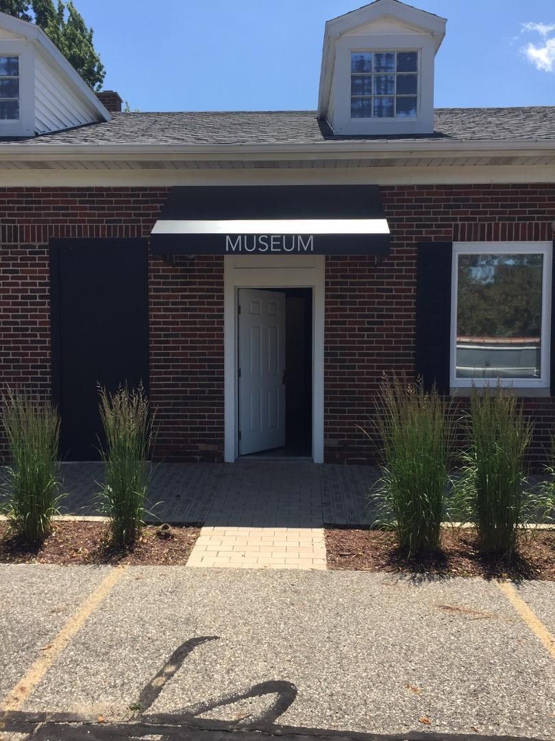 A brick building with a sign that says museum on it.