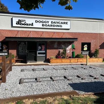 A building with a sign that says doggy daycare boarding