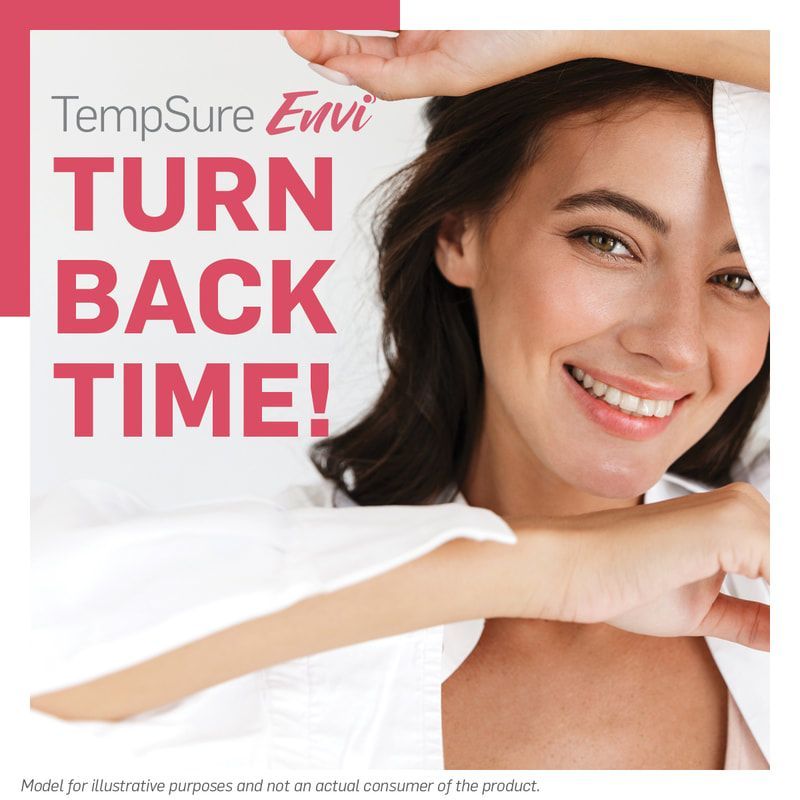 A woman is smiling in front of a sign that says turn back time.