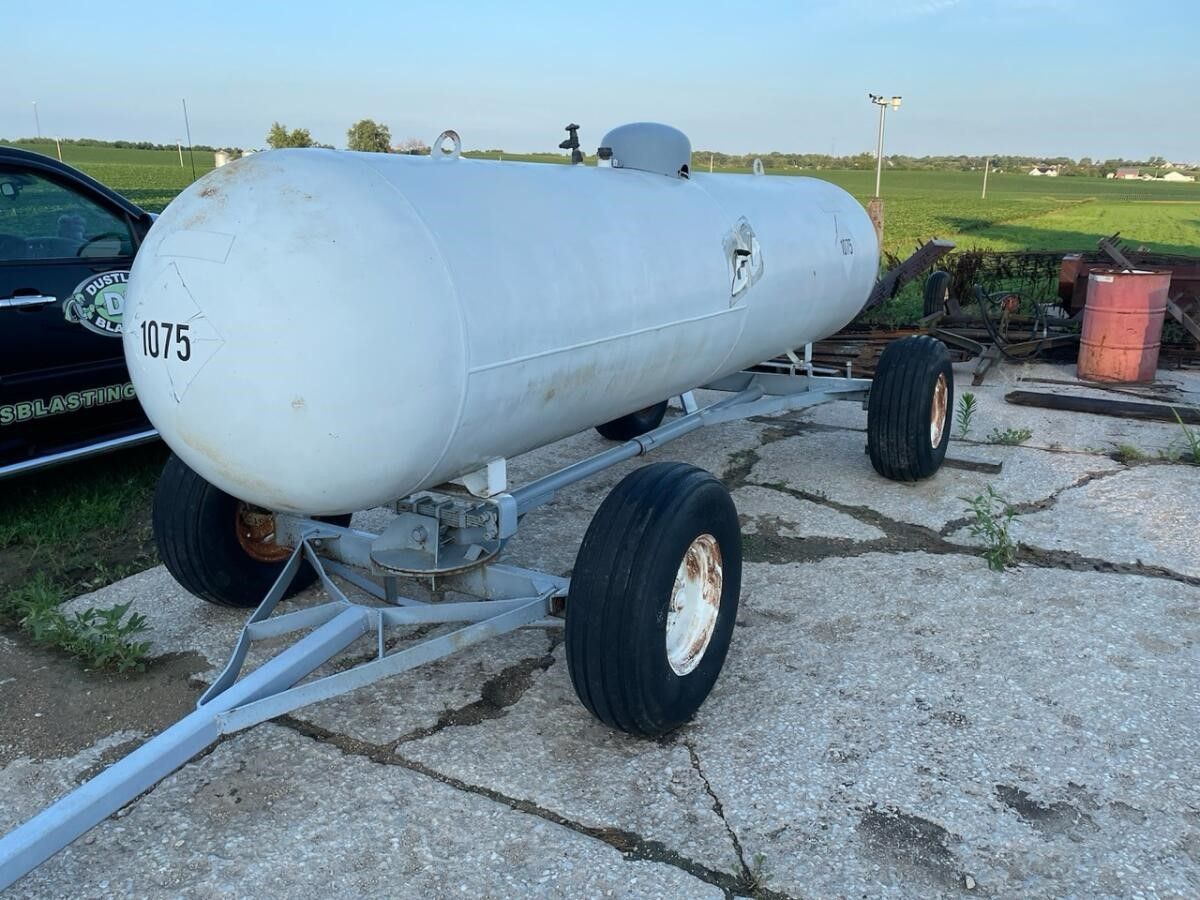a large white tank with the number 175 on it is on a trailer