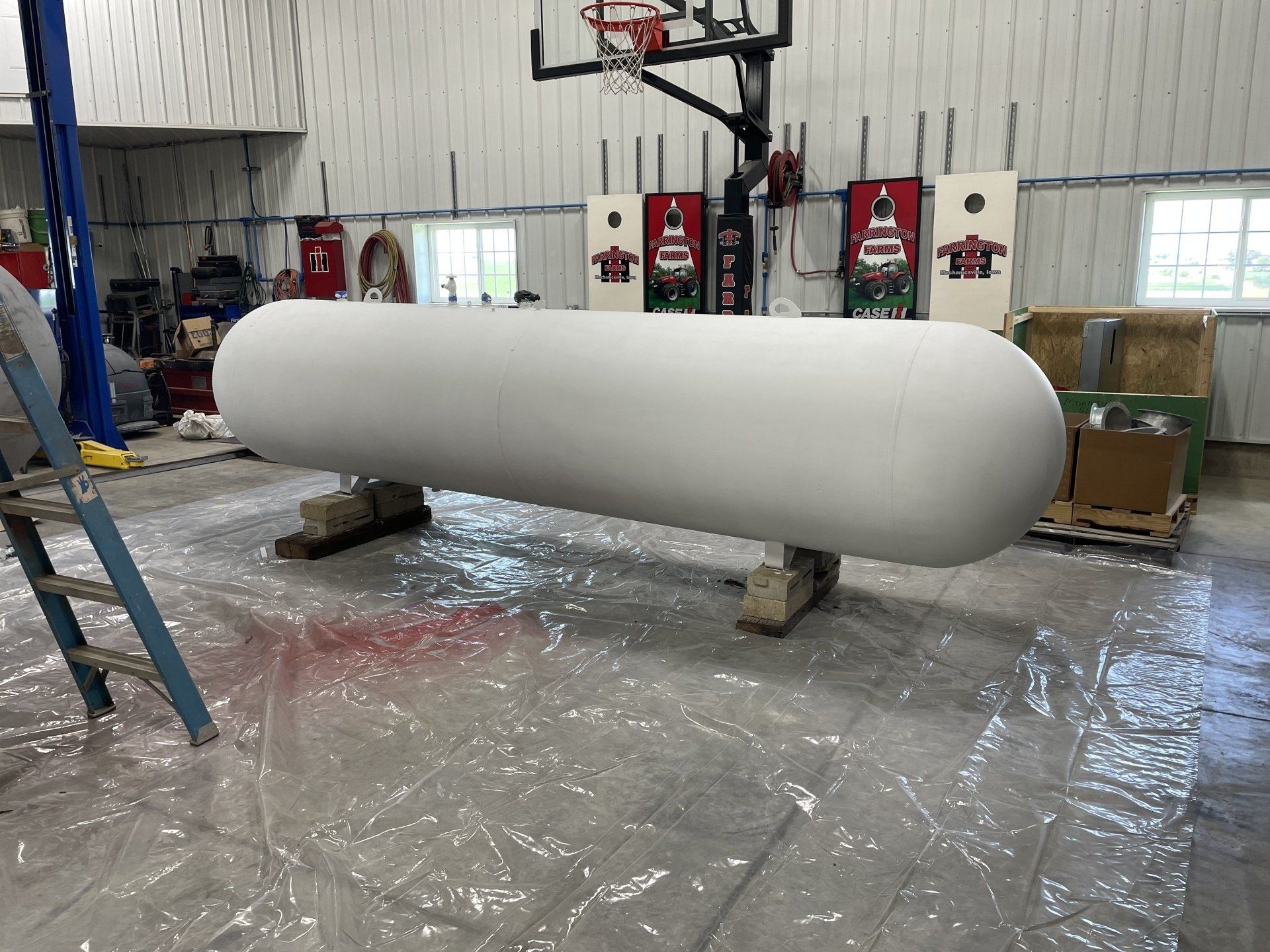 a large tank is sitting on a trailer in a field