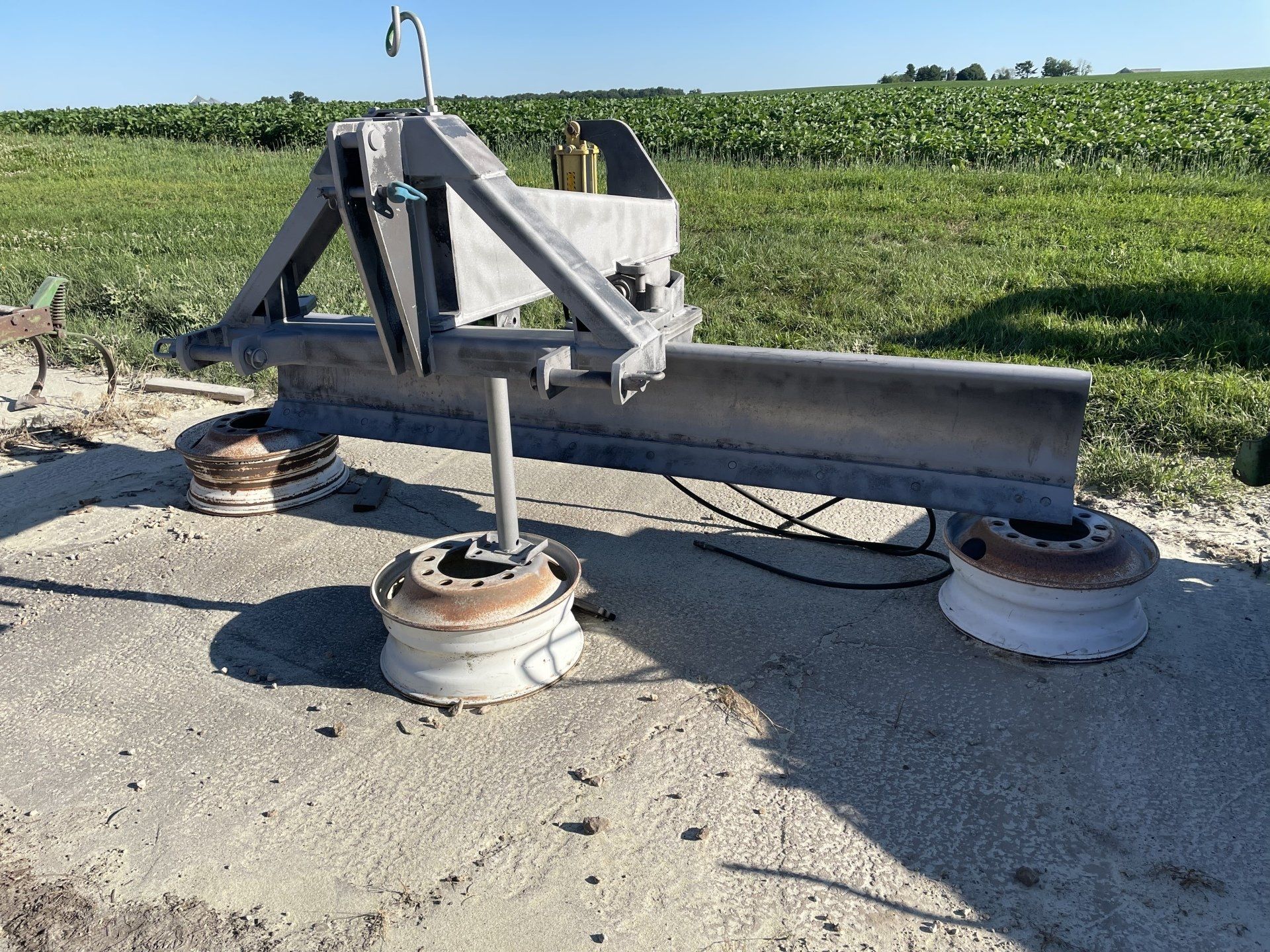 a white tractor is parked on the side of the road next to a field