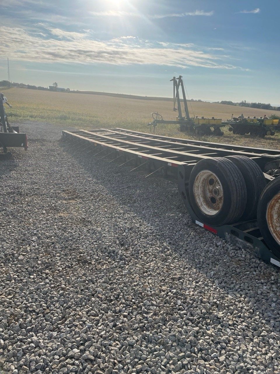 a trailer is sitting on top of a gravel road