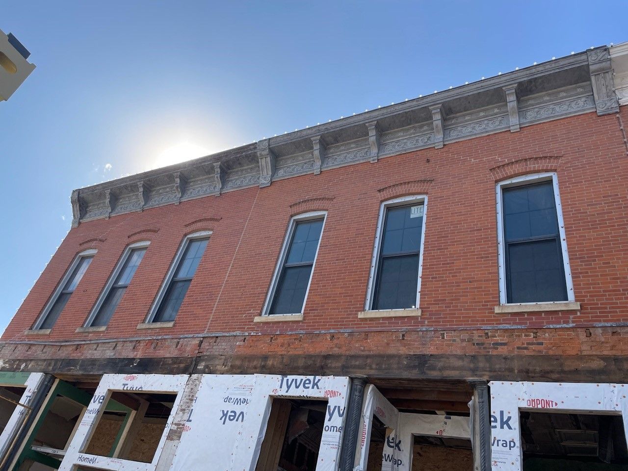 a brick building with a lot of windows is under construction