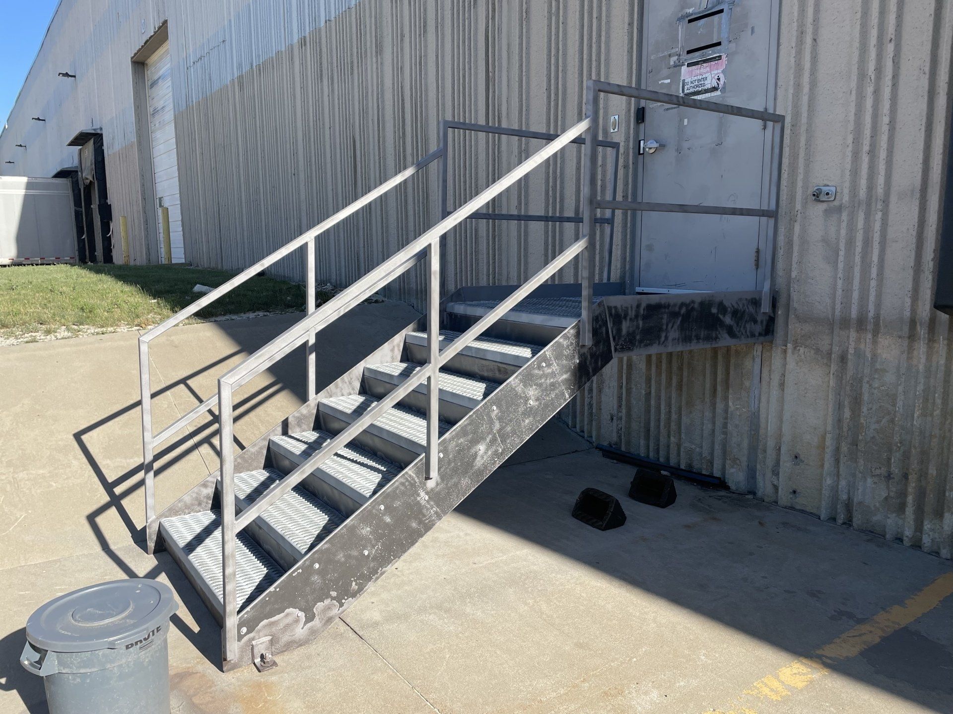 a set of stairs leading up to a building with a metal railing