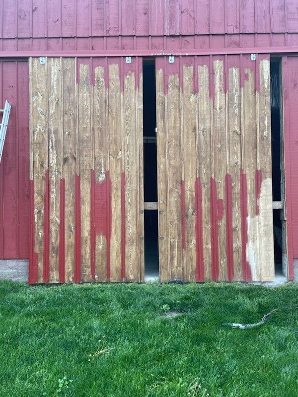 A red barn with wooden sliding doors before