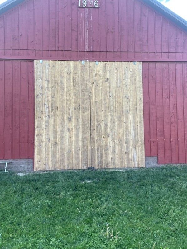 A red barn with wooden sliding doors after