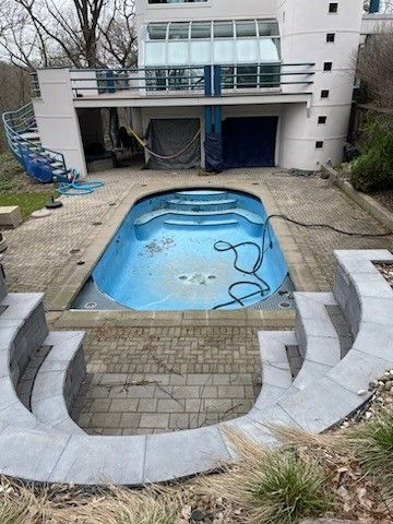 A large swimming pool in the backyard of a house before
