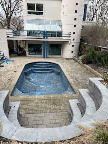 A large swimming pool in the backyard of a house after