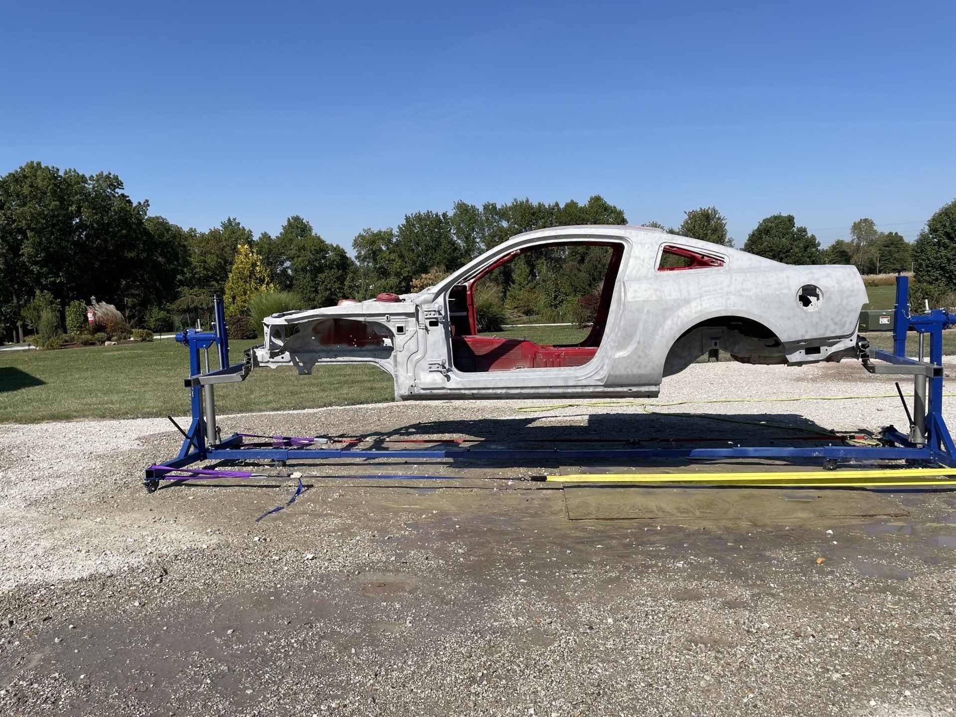 a sandblasted muscle car is sitting on top of a concrete surface