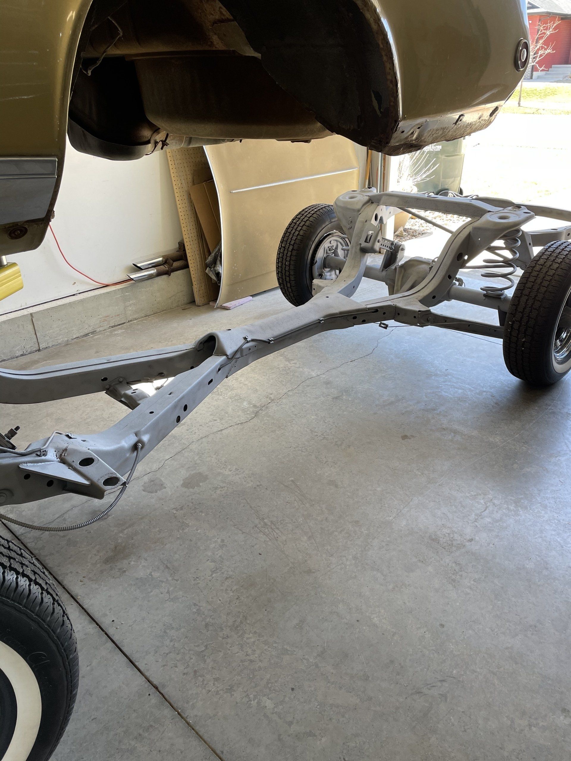 a car is sitting on a trailer in a garage
