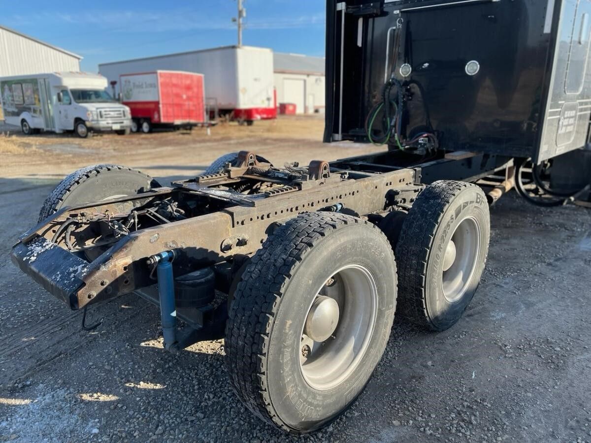 a semi truck with a trailer attached to it is parked in a parking lot