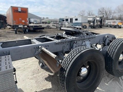 A trailer is sitting on the ground in a parking lot.