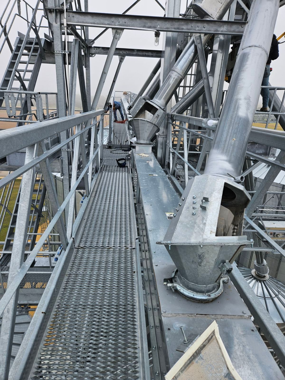 A man working on top of a metal structure