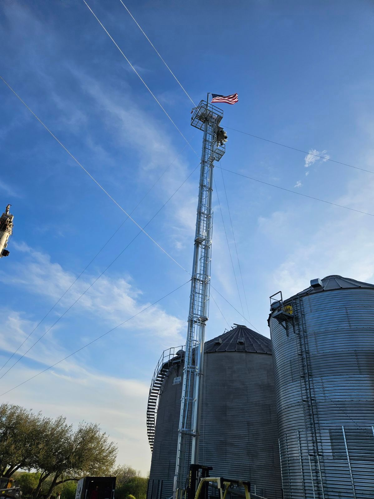 A very tall tower with an American flag on top of it