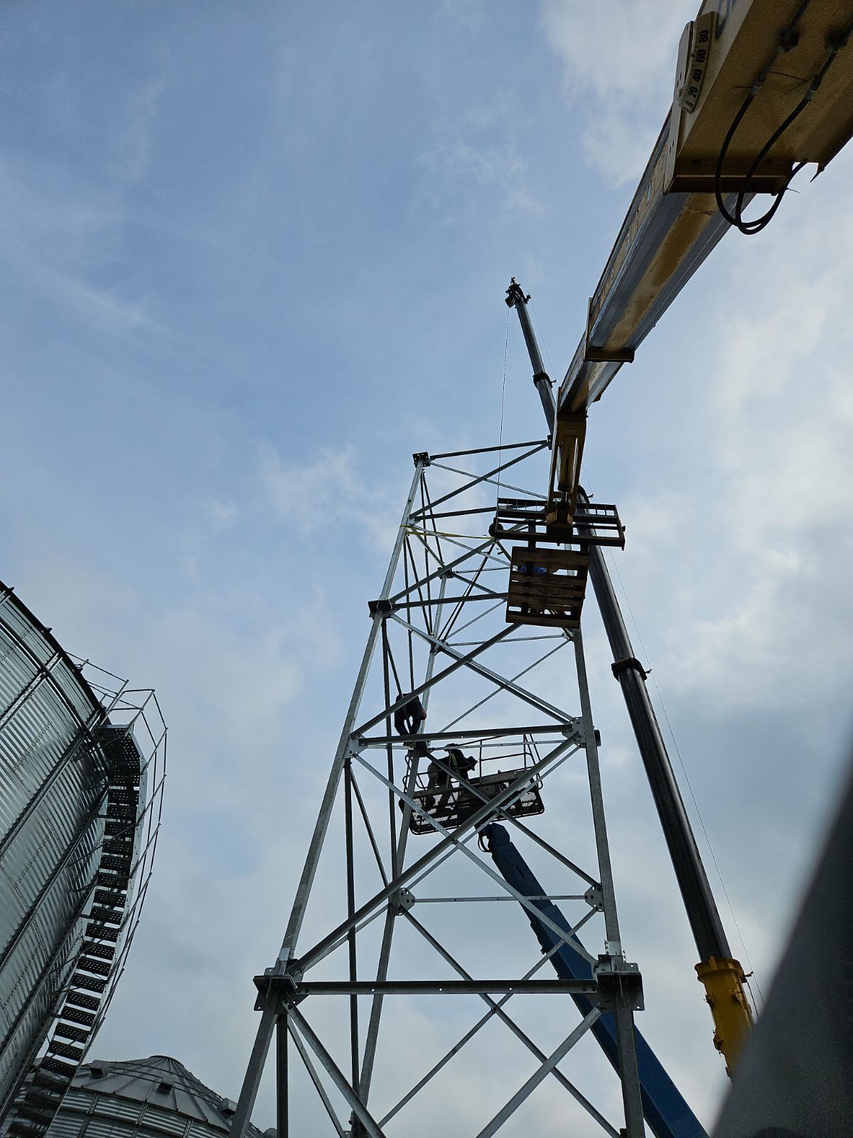 A crane is working on a very tall structure