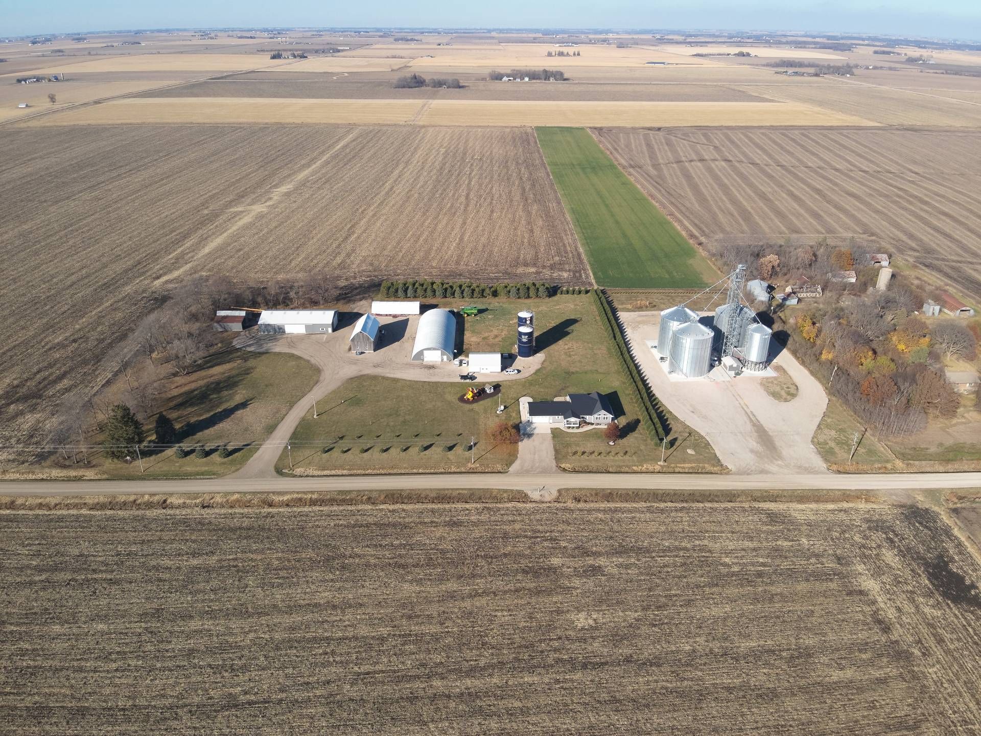 An aerial view of a farm in the middle of a field
