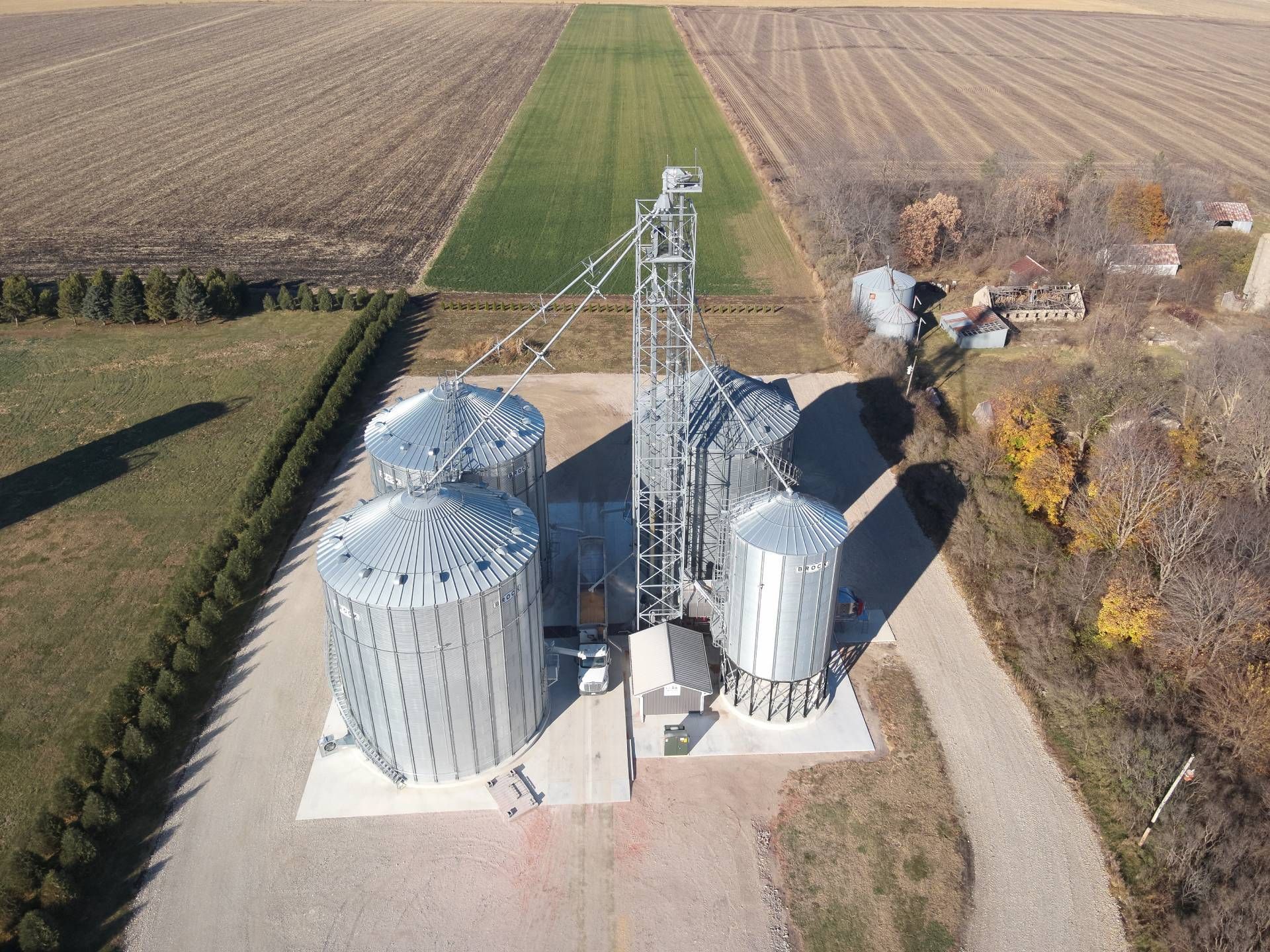 An aerial view of a grain silo in a field