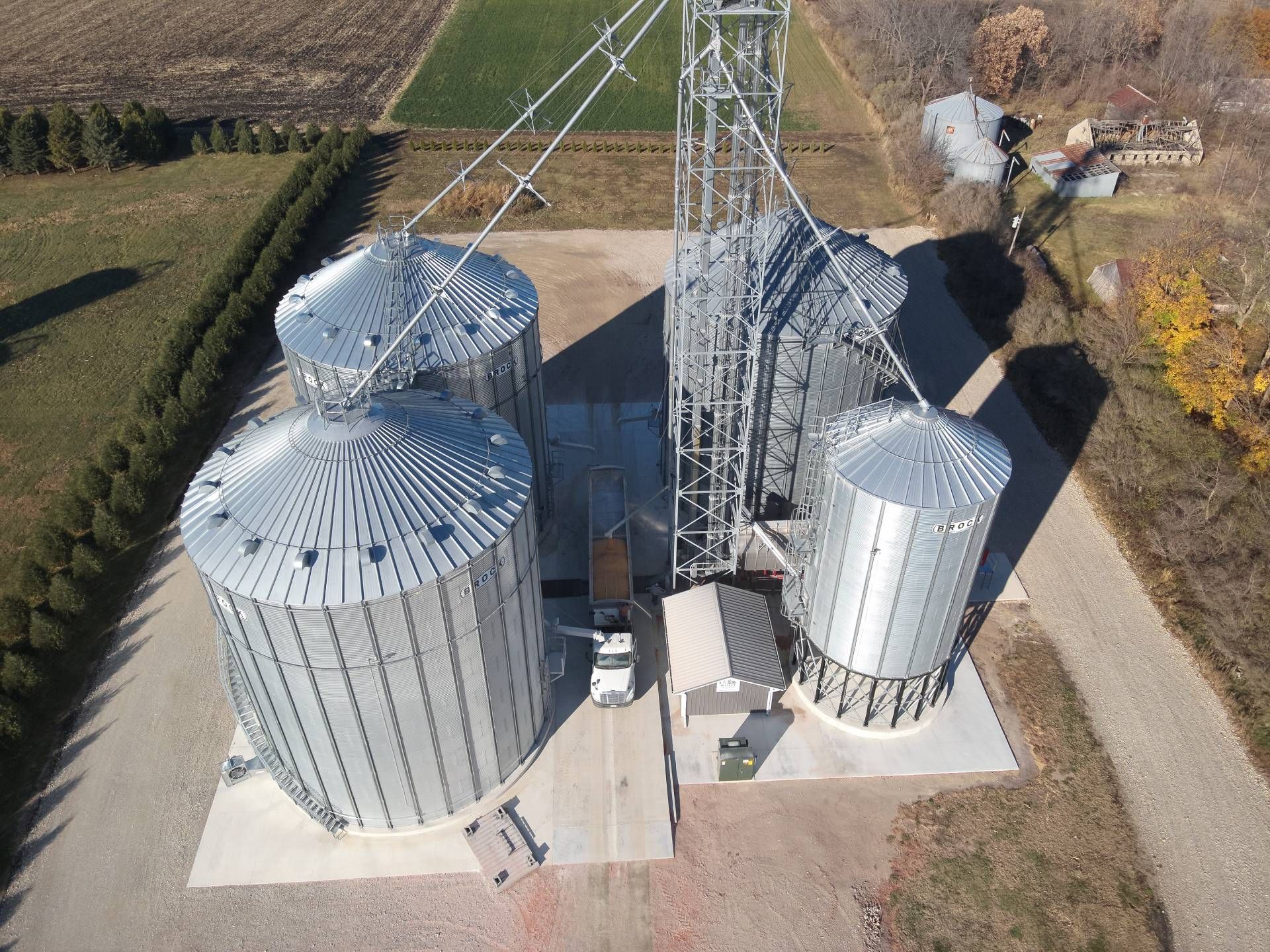 An aerial view of a grain silo in a field