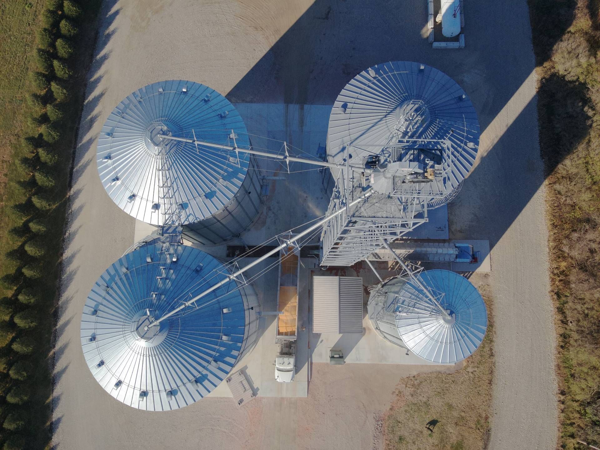 An aerial view of a grain silo in a field