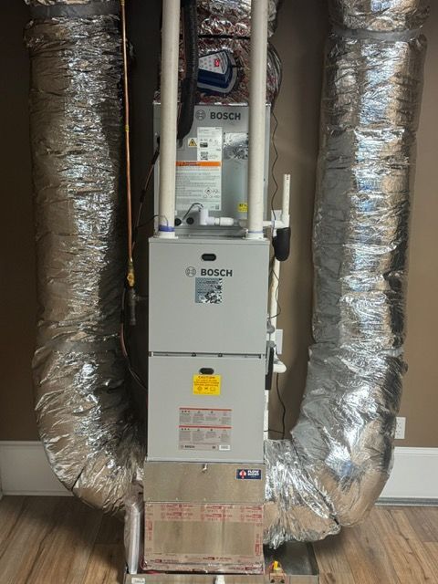 Bosch HVAC unit with silver flex ducting in a residential space.