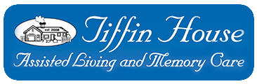 Logo for Tiffin House assisted living and memory care. Features a house graphic and script text. Blue background.