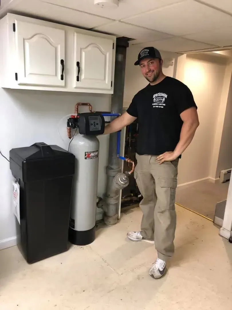 A water filter is sitting on a kitchen counter next to a sink.