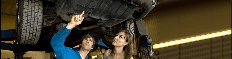 Mechanic showing the damage to the women