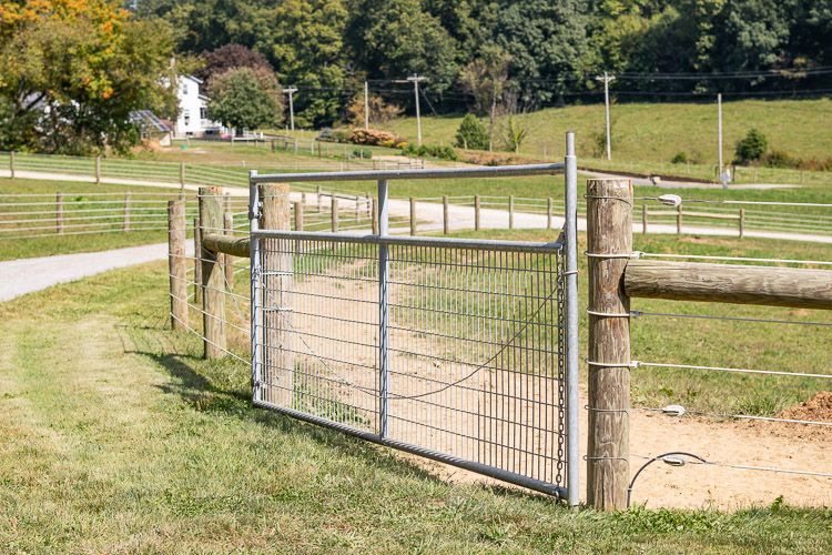 Metal gate on a wooden fence