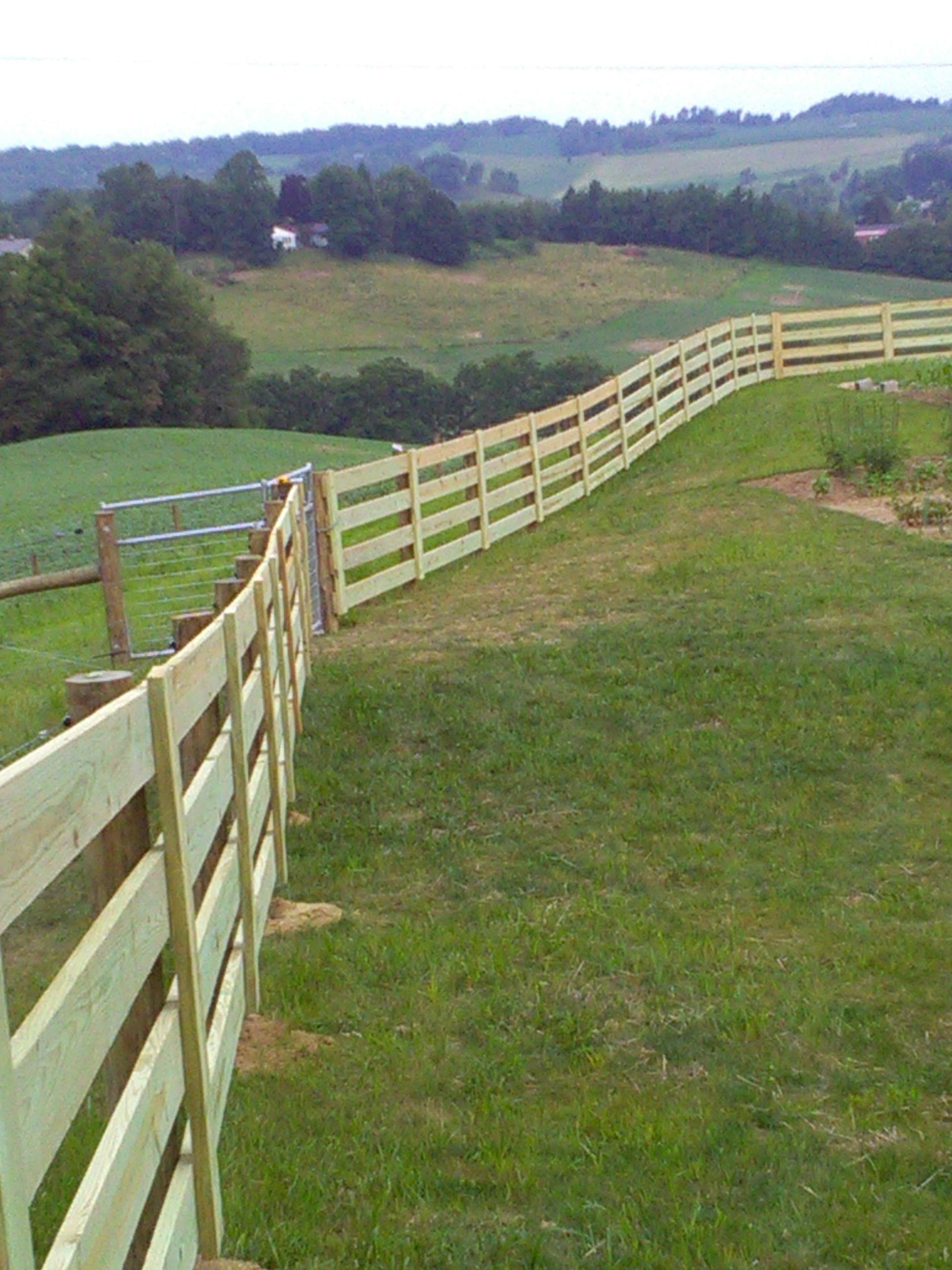 A wooden fence in a field