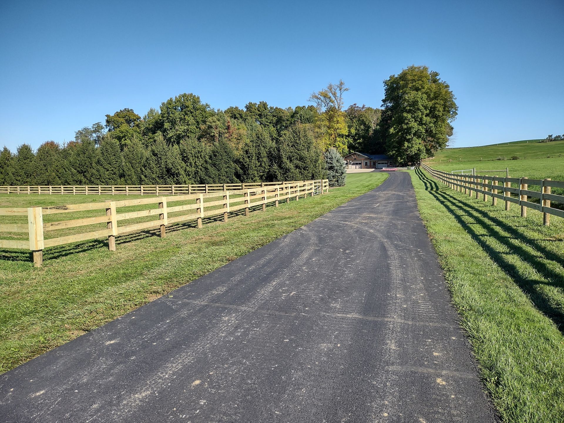 A road with a wooden fence on the side of it