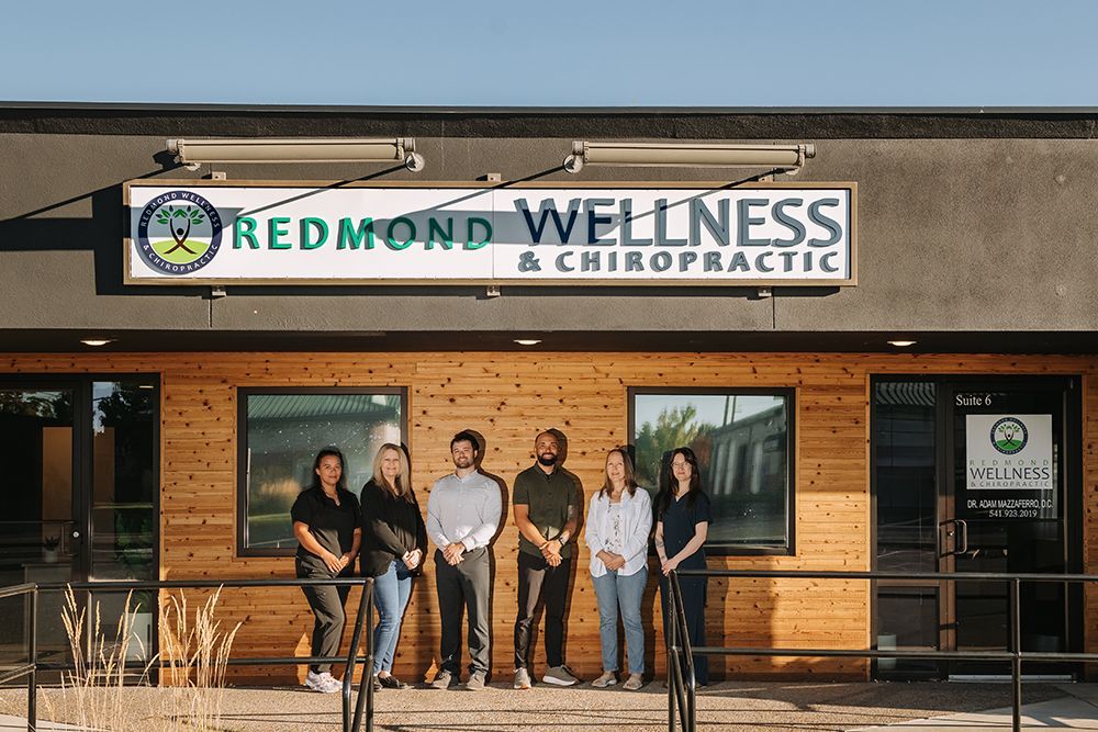 Redmond Wellness & Chiropractic storefront with six people standing on the sidewalk in front of it