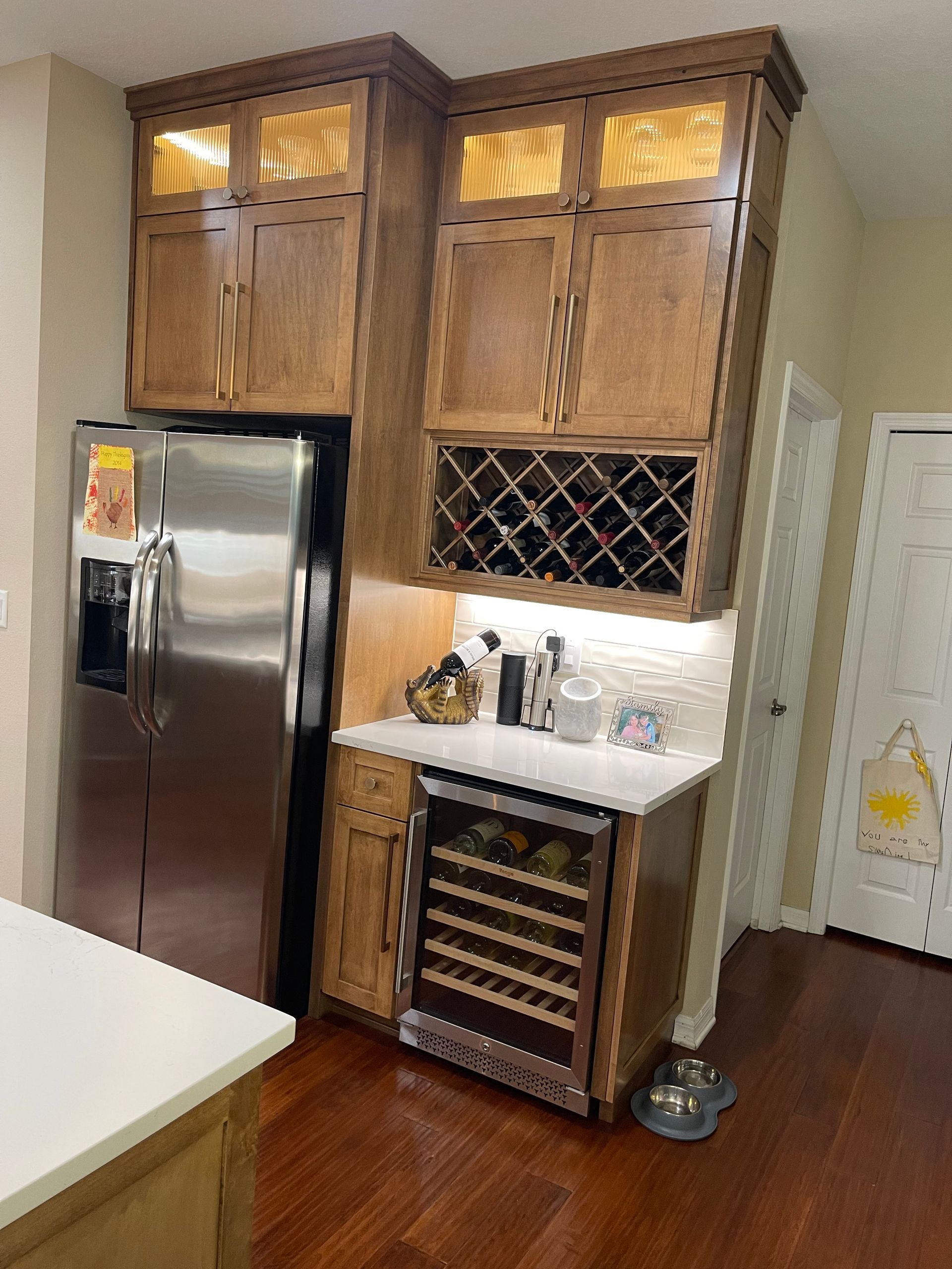 A kitchen with stainless steel appliances and wooden cabinets