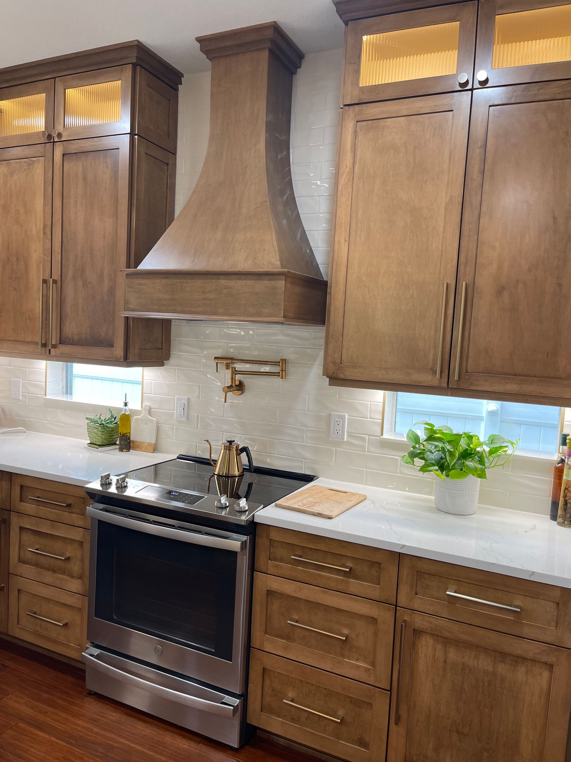 A kitchen with stainless steel appliances and wooden cabinets