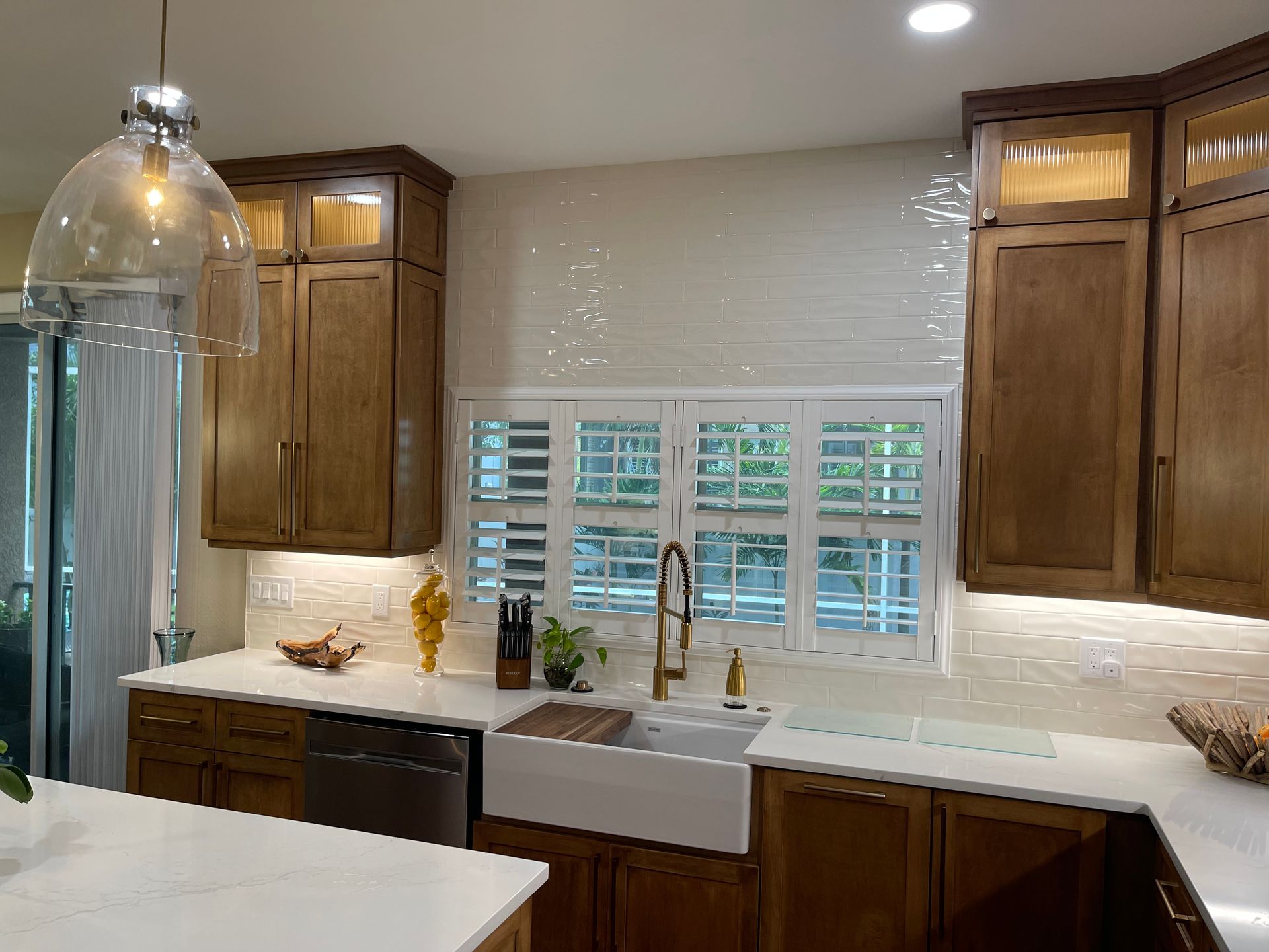 A kitchen with wooden cabinets and a white sink.