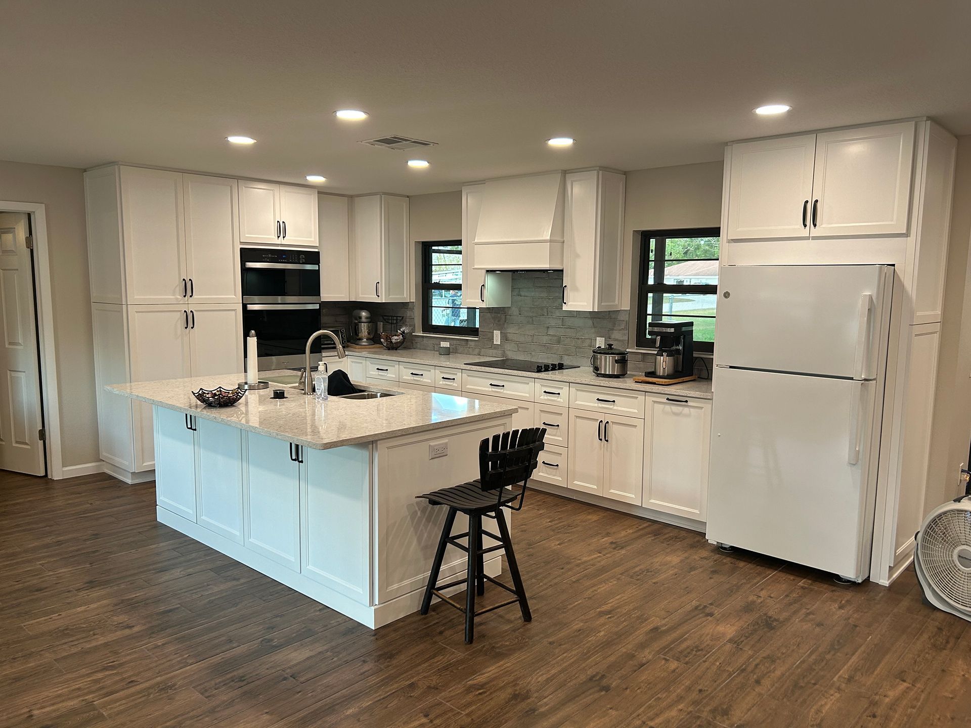 Kitchen with white cabinets and wood flooring